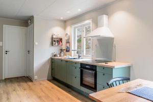 a kitchen with a sink and a stove at Karlhuset in Ramberg