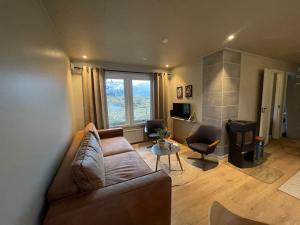 a living room with a couch and a table at Karlhuset in Ramberg