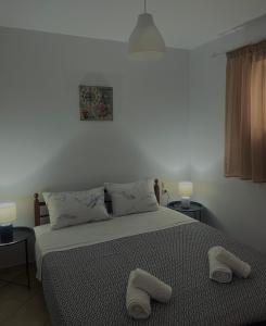 a bedroom with a bed with two stools on it at Family House Dim in Ioannina +25 photos