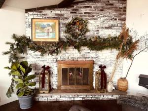 un camino con corone di Natale su un muro di mattoni di Majestic Lake Front Chalet a Tobyhanna Altre 37 foto