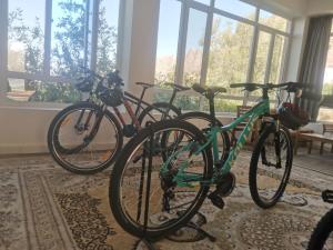 three bikes parked next to each other in a room at Hadash guest house in Ghubrah