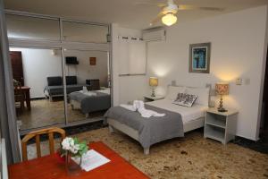 a bedroom with a bed and a living room at Villa Baya in Bayahibe