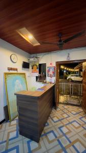 a bar in a restaurant with a clock on the wall at Kashid Sunrise Resort in Kashid