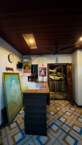 a living room with a counter and a room with a clock at Kashid Sunrise Resort in Kashid