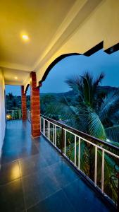 a balcony of a house with a view of the ocean at Kashid Sunrise Resort in Kashid