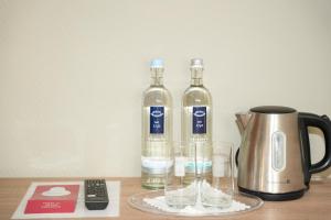 two bottles of wine and glasses on a table at Angelis Pension Frankfurt Airport in Kelsterbach