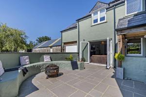 a backyard with a patio and a house at Willow Lodge, Wolfscastle in Haverfordwest