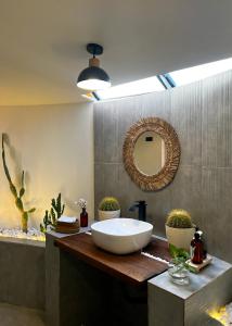 a bathroom with a large bowl sink and a mirror at La Duna Desert Camp in Shāhiq