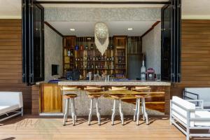 a bar in a room with wooden walls and stools at Oceana by ABNA in Playa del Carmen