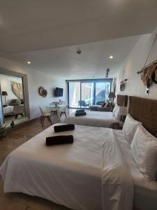 a bedroom with two beds and a living room at Oceana by ABNA in Playa del Carmen +82 photos