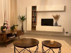 a living room with two tables and a flat screen tv at Vintage dream in Heide