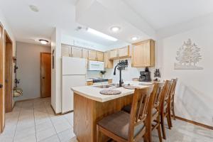 a kitchen with wooden cabinets and a white refrigerator at NE16-2 Sleepy Bear Camp condo in Branson West