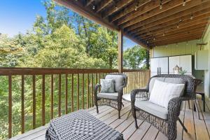 two wicker chairs and a table on a deck at NE16-2 Sleepy Bear Camp condo in Branson West +26 photos