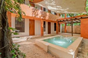 an outdoor hot tub in a courtyard of a house at Mamachá - Natural Residence in Valladolid