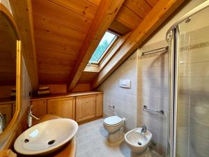 a bathroom with a sink and a toilet and a window at Alpine Escape 4 in Bormio +4 photos