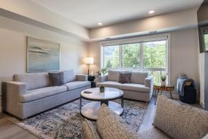 a living room with two couches and a table at Serenity at Sparrowhawk Lodge Brand New 2Bd 2Ba in Dead Man's Flats