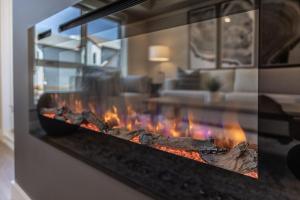 a fireplace in a living room with flames in it at Serenity at Sparrowhawk Lodge Brand New 2Bd 2Ba in Dead Man's Flats