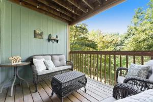 a porch with a couch and chairs on a deck at NE16-2 Sleepy Bear Camp condo in Branson West