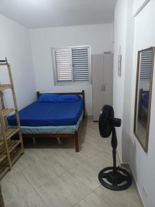 a bedroom with a bed and a ladder and a chair at Apartamento Vista Mar Praia Grande, Ocian in Praia Grande +16 photos