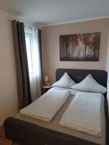 a bedroom with two beds and a picture on the wall at Ferienwohnung Luitpold 2 in Memmingen +6 photos