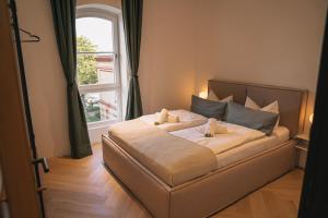 a bedroom with a large bed with a window at RR - Penthouse - Luxe 105 qm - Central - WIFI in Magdeburg
