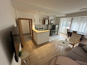 Una sala de estar y una cocina con un sofá y una mesa. en Ira's Square 2 Bedroom Apt Free Parking, en Skopje