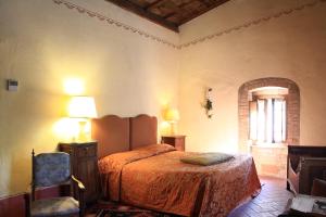 Ένα ή περισσότερα κρεβάτια σε δωμάτιο στο La Locanda del Loggiato