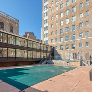 a tennis court in front of a building at East 419i Modern Suite I Pool I Gym in Rochester