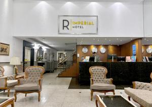a lobby of a hotel with chairs and a counter at Riale Imperial Flamengo in Rio de Janeiro