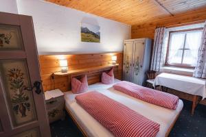 a bedroom with two beds in a wooden cabin at Schallerhof in Neustift im Stubaital