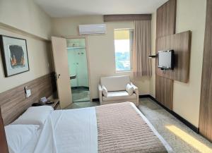 Cama ou camas em um quarto em Via Contorno Hotel