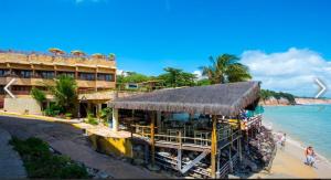 a hotel on a beach with the ocean at PIPAs BAY APARTHOTEL in Pipa