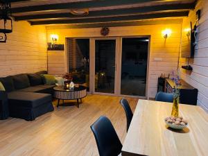 a living room with a table and a couch at Kukułka Mazury in Ruciane-Nida