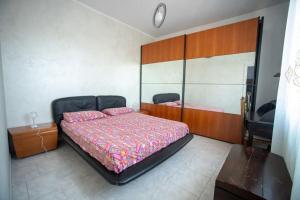 a bedroom with a large bed and a wooden headboard at A casa di Rosa in Pavia