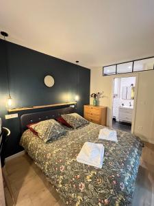 a bedroom with a bed with two books on it at The Little Studio in Strasbourg