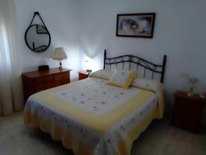 a bedroom with a large bed and two night stands at Casa La Laguneta in Arcos de la Frontera
