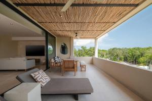 a living room with a couch and a table at Jungle Sky Loft in Tulum