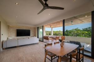 a living room with a couch and a table at Jungle Sky Loft in Tulum