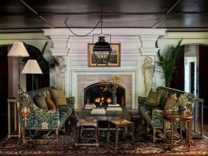 a living room with two couches and a fireplace at La Playa Hotel in Carmel