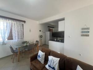 a living room with a couch and a table at Near Beach 2 Bed Apt in Tarrafal