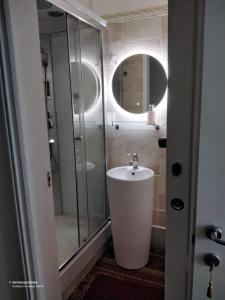 a bathroom with a sink and a glass shower at B& B Cà de Andreas in Catania +17 photos