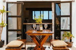 a table with two wine glasses on top of it at Casa De Surfos Cerritos’s Beach in San Carlos