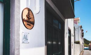 a sign on the side of a building at Guest House Genuíno in Horta