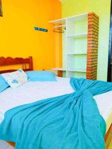 un letto con una coperta blu sopra di 6 - Apartamento de 02 quartos com jacuzzi em Bombas a Bombinhas