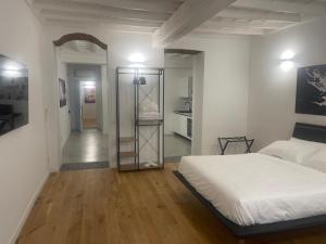 a white bedroom with a bed and a mirror at Principessa Isabella in Turin