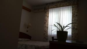 Postel nebo postele na pokoji v ubytování Hotel Le Viole