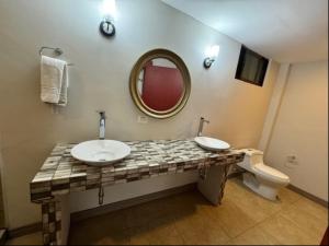 a bathroom with a sink and a mirror and a toilet at Rancho Humo Estancia in Puerto Humo +37 photos