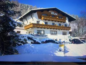a large building with snow on the ground at Pension Razil XO in Ladis