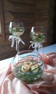 two wine glasses sitting on top of a table at Guest House Kalniņi in Kārļi