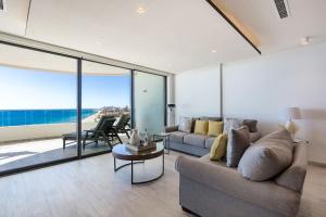 a living room with a couch and a view of the ocean at Oceanfront Vibes Iconic Beachside Getaway in Puerto Peñasco